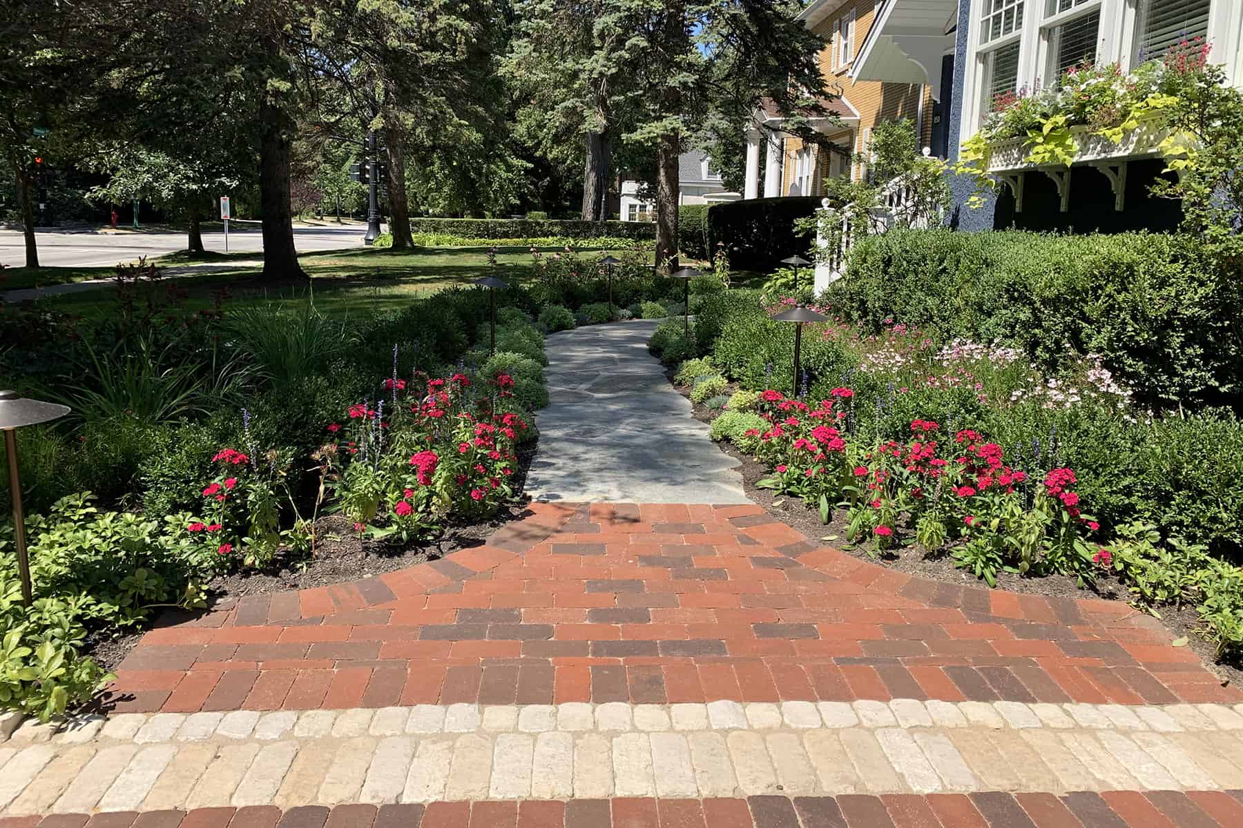 Flagstone walkway with clay paver apron