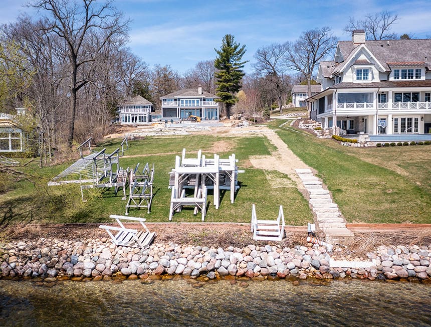 Before renovation view of a sloped lakeside yard in Williams Bay, Wisconsin, showing uneven terrain and limited circulation.
